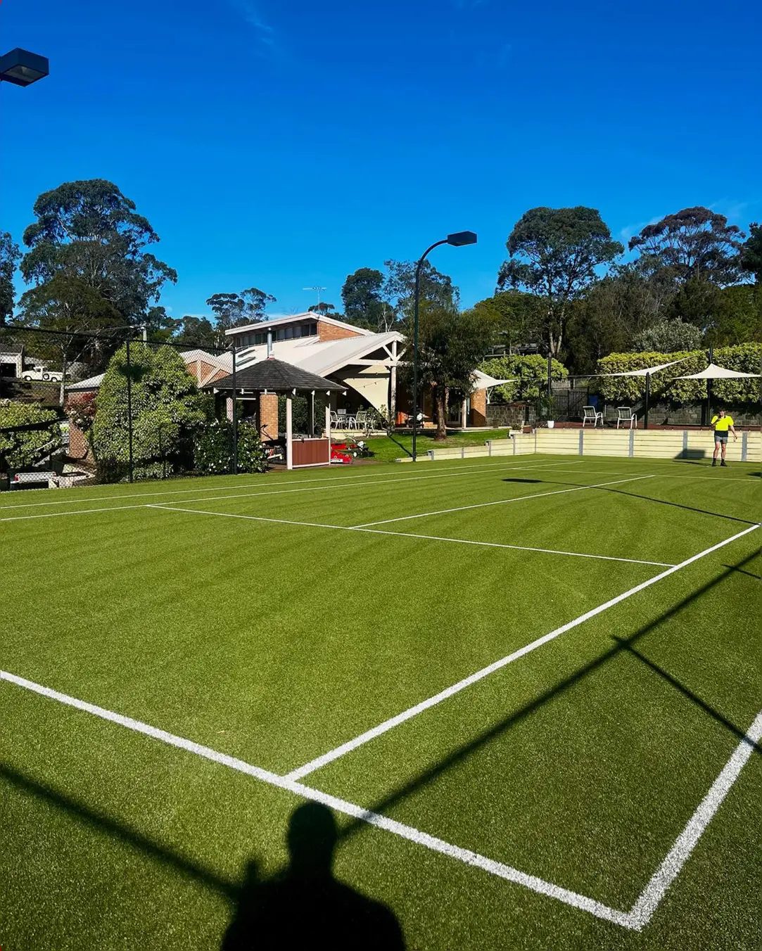 Tennis court after, clean and green with bright lines